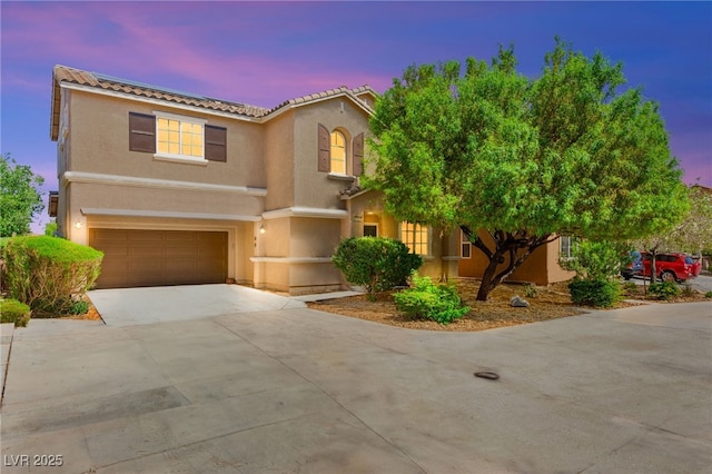 8316 Mokena Ave, Las Vegas, NV 89178 - view of front of house featuring an attached garage, concrete driveway, a tile roof, and stucco siding