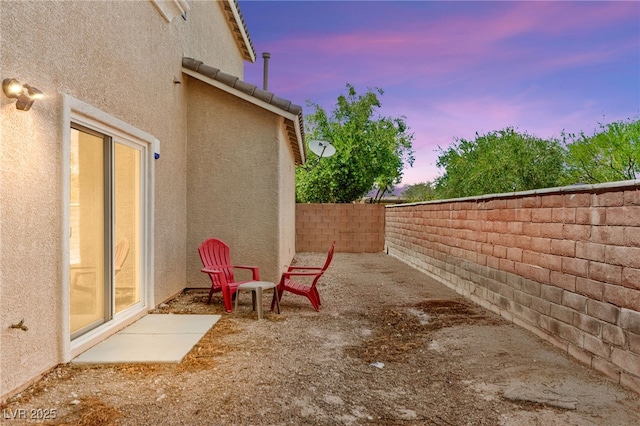 8316 Mokena Ave, Las Vegas, NV 89178 - patio terrace at dusk featuring a fenced backyard and a patio