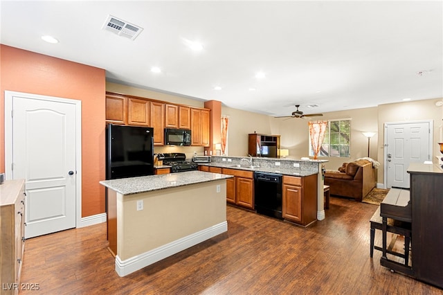 8316 Mokena Ave, Las Vegas, NV 89178 - kitchen with black appliances, a peninsula, open floor plan, dark wood-style flooring, and brown cabinets