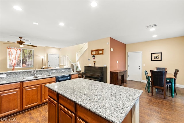 8316 Mokena Ave, Las Vegas, NV 89178 - kitchen with dark wood finished floors, ceiling fan, dishwasher, brown cabinets, and recessed lighting