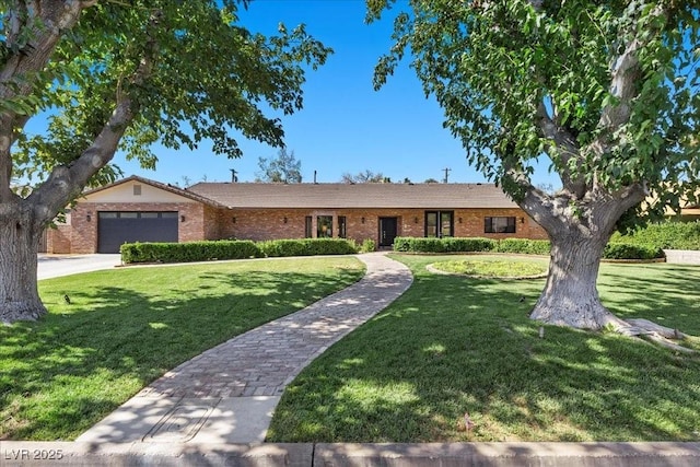 3104 Conners Dr, Las Vegas, NV 89107 - ranch-style home featuring a front lawn, an attached garage, brick siding, and concrete driveway