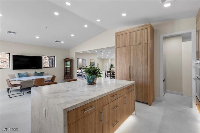 3104 Conners Dr, Las Vegas, NV 89107 - kitchen with modern cabinets, lofted ceiling, a kitchen island, open floor plan, and recessed lighting