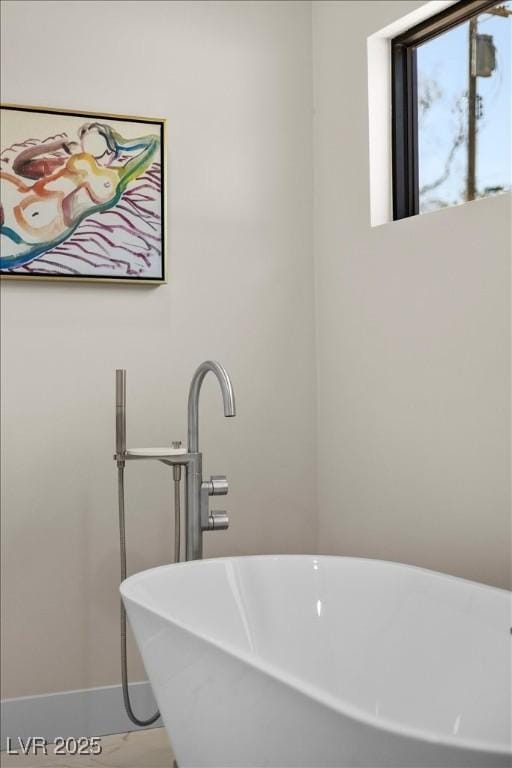 3104 Conners Dr, Las Vegas, NV 89107 - bathroom featuring a soaking tub and baseboards