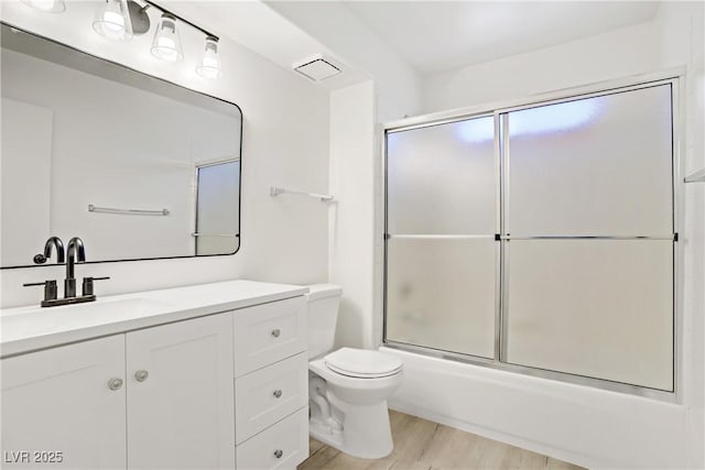 3455 Erva St Unit 112, Las Vegas, NV 89117 - bathroom featuring vanity, wood finished floors, and enclosed tub / shower combo