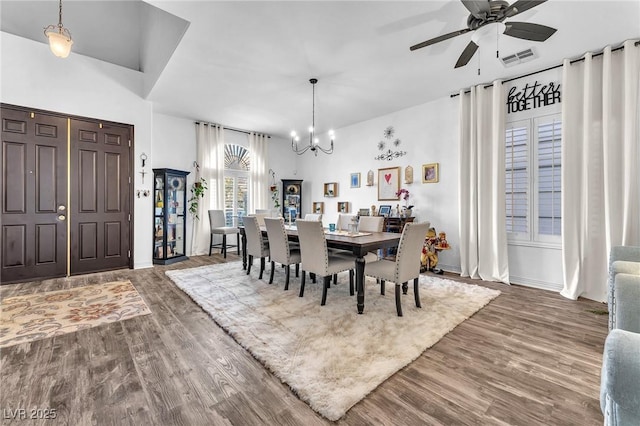 10654 Sidlaw Hills Ct, Las Vegas, NV 89141 - dining space with wood finished floors, a chandelier, and a ceiling fan