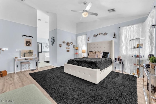 10654 Sidlaw Hills Ct, Las Vegas, NV 89141 - bedroom with light wood-style flooring, lofted ceiling, and a ceiling fan
