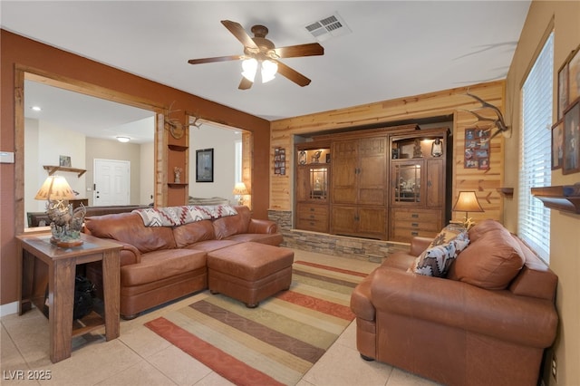 4415 Peaceful Harbor St, Las Vegas, NV 89129 - living room featuring a ceiling fan, wooden walls, and light tile patterned floors
