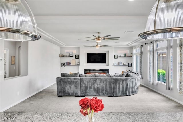 5976 Rockway Glen Ave, Las Vegas, NV 89141 - carpeted living room featuring a ceiling fan and a glass covered fireplace
