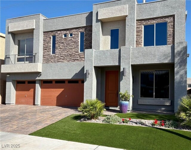 5976 Rockway Glen Ave, Las Vegas, NV 89141 - contemporary home with stucco siding, stone siding, and a garage