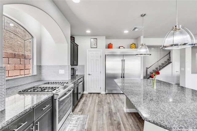 5976 Rockway Glen Ave, Las Vegas, NV 89141 - kitchen with appliances with stainless steel finishes, light stone countertops, recessed lighting, light wood finished floors, and decorative backsplash