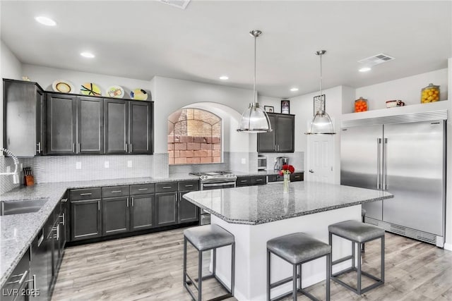 5976 Rockway Glen Ave, Las Vegas, NV 89141 - kitchen featuring appliances with stainless steel finishes, a kitchen breakfast bar, light wood-style flooring, and recessed lighting