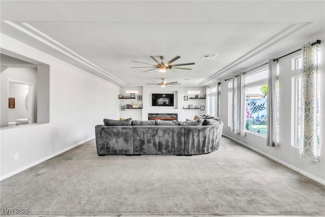 5976 Rockway Glen Ave, Las Vegas, NV 89141 - living room with carpet, ceiling fan, and a glass covered fireplace
