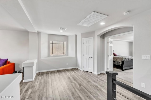 5976 Rockway Glen Ave, Las Vegas, NV 89141 - empty room with light wood-style floors, recessed lighting, arched walkways, and a smoke detector