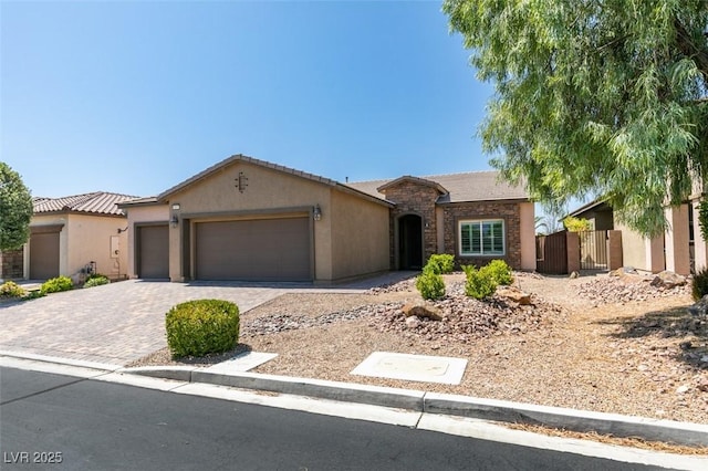 6085 Ryan Ranch Ave, Las Vegas, NV 89130 - view of front facade with an attached garage, stucco siding, decorative driveway, and a tiled roof