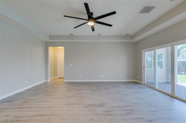 6085 Ryan Ranch Ave, Las Vegas, NV 89130 - spare room featuring light wood-style flooring, ceiling fan, and a tray ceiling