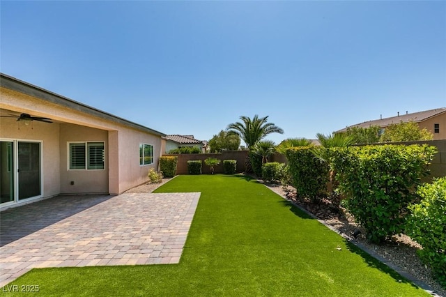 6085 Ryan Ranch Ave, Las Vegas, NV 89130 - fenced backyard with ceiling fan and a patio area