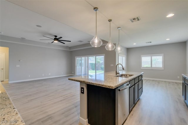 6085 Ryan Ranch Ave, Las Vegas, NV 89130 - kitchen with dishwasher, light wood-style floors, ceiling fan, hanging light fixtures, and an island with sink