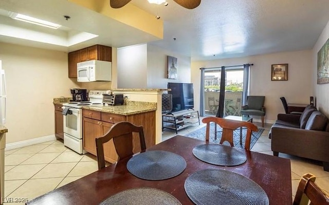 4200 S Valley View Blvd Unit 1077, Las Vegas, NV 89103 - kitchen featuring white appliances, light tile patterned floors, brown cabinets, and open floor plan