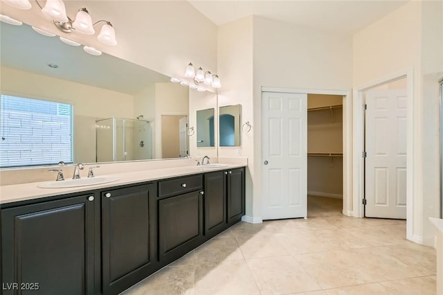 9252 Oxbow Lake Ave, Las Vegas, NV 89149 - full bath featuring a shower stall, double vanity, tile patterned floors, and a walk in closet