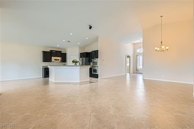 9252 Oxbow Lake Ave, Las Vegas, NV 89149 - unfurnished living room with a chandelier, light tile patterned flooring, high vaulted ceiling, and arched walkways