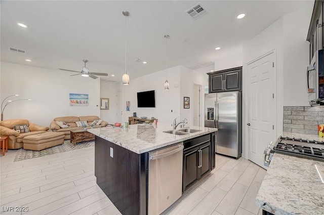 794 Sunny Sagebrush St, Henderson, NV 89011 - kitchen with stainless steel appliances, open floor plan, an island with sink, pendant lighting, and recessed lighting