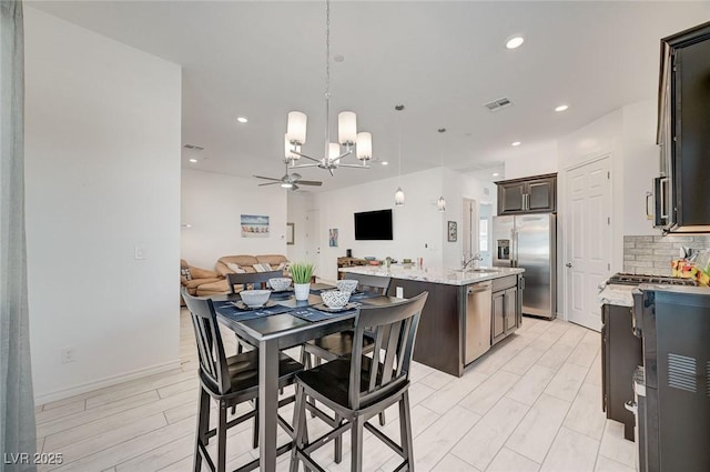 794 Sunny Sagebrush St, Henderson, NV 89011 - dining room with a chandelier, a ceiling fan, and recessed lighting