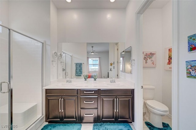 794 Sunny Sagebrush St, Henderson, NV 89011 - bathroom featuring a stall shower, double vanity, ceiling fan, and tile patterned flooring