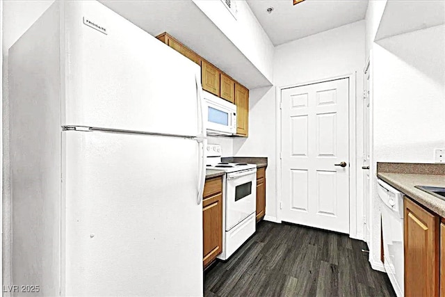 6955 N Durango Dr Unit 1022, Las Vegas, NV 89149 - kitchen featuring white appliances, brown cabinets, and dark wood-style flooring