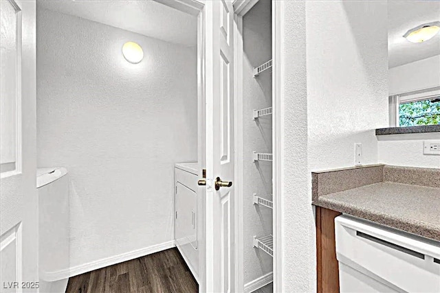 6955 N Durango Dr Unit 1022, Las Vegas, NV 89149 - bathroom featuring wood finished floors, a textured wall, a spacious closet, and vanity