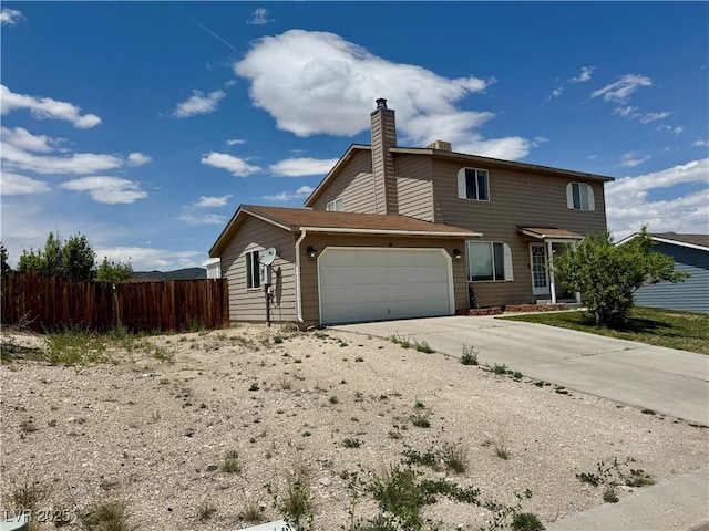 2345 Iron Dr, Ely, NV 89301 - view of front of home featuring a garage, concrete driveway, and a chimney