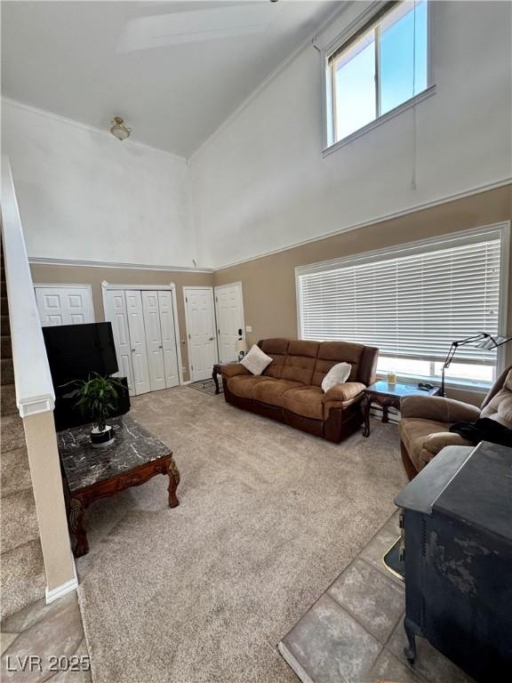 2345 Iron Dr, Ely, NV 89301 - living area featuring high vaulted ceiling, carpet floors, and stairway