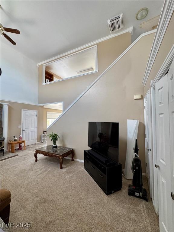 2345 Iron Dr, Ely, NV 89301 - carpeted living area featuring ceiling fan and a high ceiling