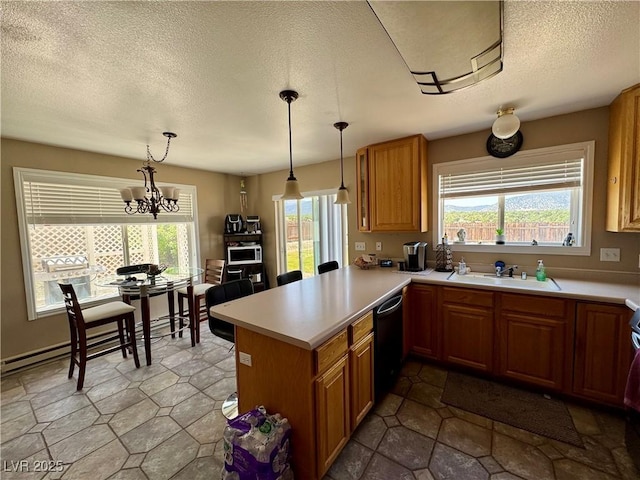 2345 Iron Dr, Ely, NV 89301 - kitchen with dishwasher, a textured ceiling, light countertops, a peninsula, and decorative light fixtures