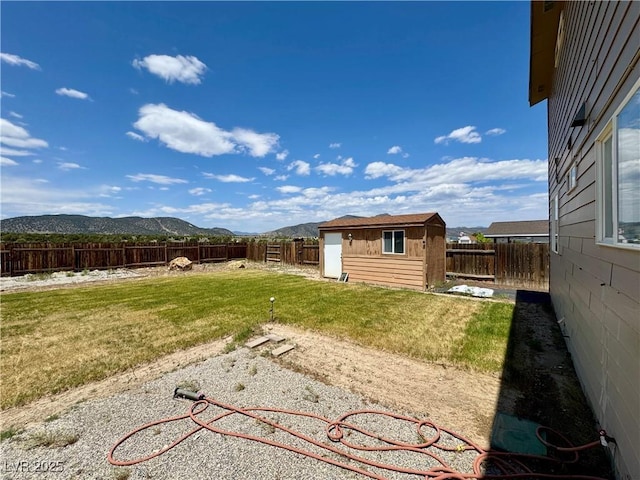 2345 Iron Dr, Ely, NV 89301 - fenced backyard featuring a mountain view and an outbuilding