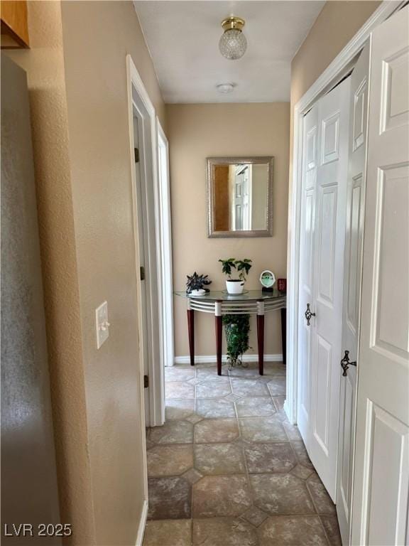 2345 Iron Dr, Ely, NV 89301 - hallway with baseboards and stone finish flooring