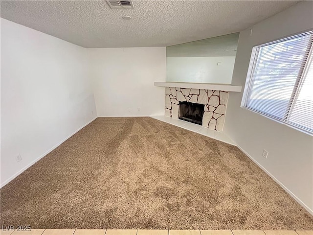7948 Calico Vista Blvd Unit 101, Las Vegas, NV 89128 - unfurnished living room featuring carpet flooring, a fireplace, and a textured ceiling