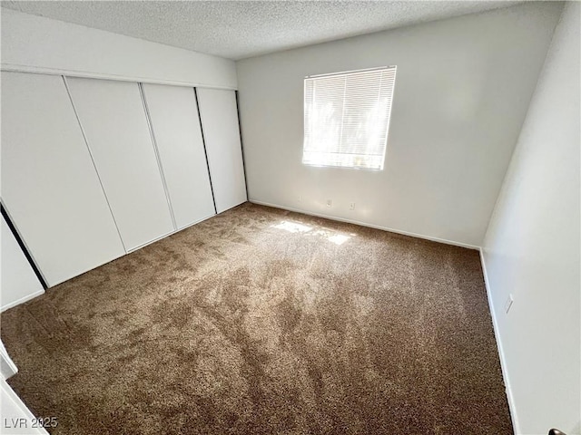 7948 Calico Vista Blvd Unit 101, Las Vegas, NV 89128 - unfurnished bedroom featuring carpet floors, a closet, and a textured ceiling