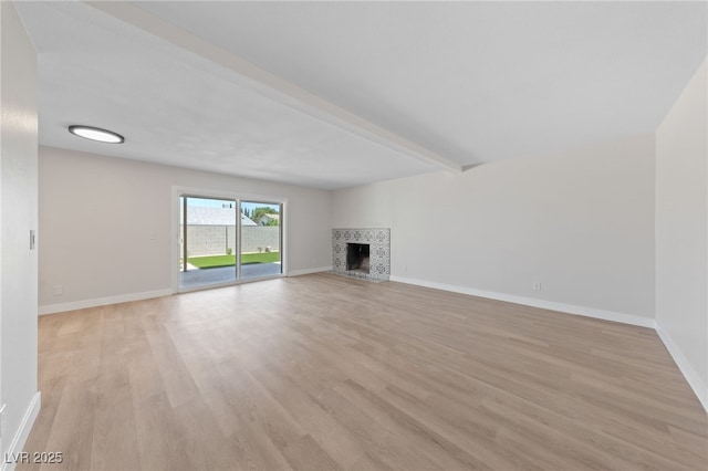 1511 Irene Dr, Boulder City, NV 89005 - unfurnished living room featuring light wood-style floors, a fireplace, and beam ceiling
