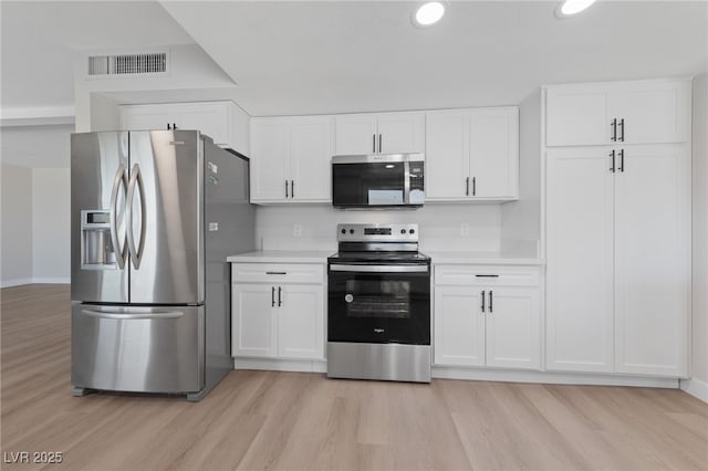1511 Irene Dr, Boulder City, NV 89005 - kitchen featuring appliances with stainless steel finishes, light wood-type flooring, light countertops, white cabinetry, and recessed lighting