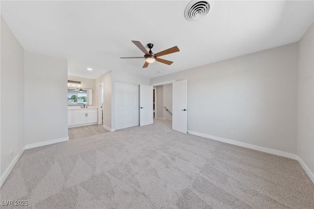 1511 Irene Dr, Boulder City, NV 89005 - unfurnished bedroom with light carpet, ensuite bathroom, recessed lighting, and a ceiling fan