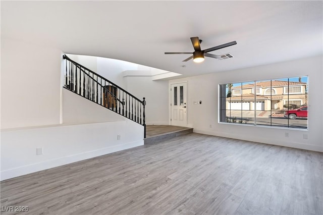 9541 Summersweet Ct, Las Vegas, NV 89123 - unfurnished living room with wood finished floors, a ceiling fan, and stairs