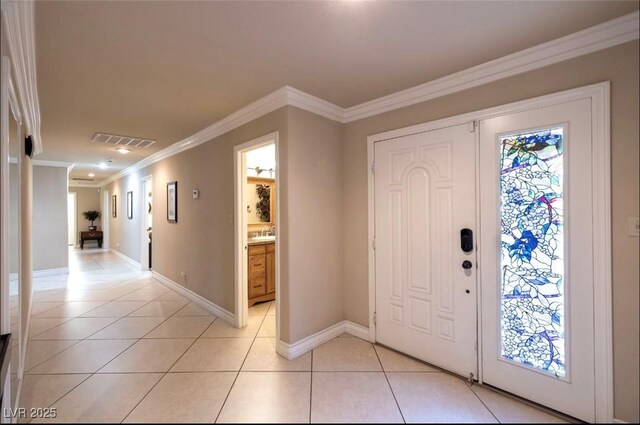 3597 Cochise Ln, Las Vegas, NV 89169 - foyer featuring light tile patterned floors and ornamental molding