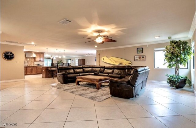 3597 Cochise Ln, Las Vegas, NV 89169 - living room with crown molding, ceiling fan, light tile patterned floors, recessed lighting, and a chandelier