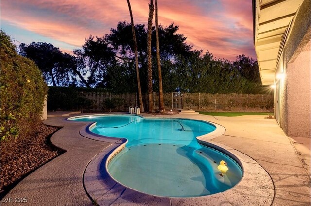 3597 Cochise Ln, Las Vegas, NV 89169 - pool at dusk with a patio and a fenced backyard