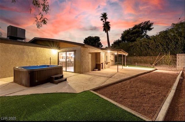 3597 Cochise Ln, Las Vegas, NV 89169 - rear view of house with a hot tub, a patio, and stucco siding