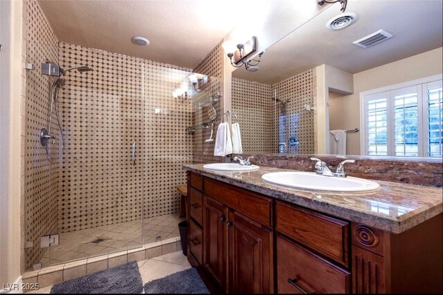 3597 Cochise Ln, Las Vegas, NV 89169 - full bathroom with a shower stall, double vanity, and tile patterned floors