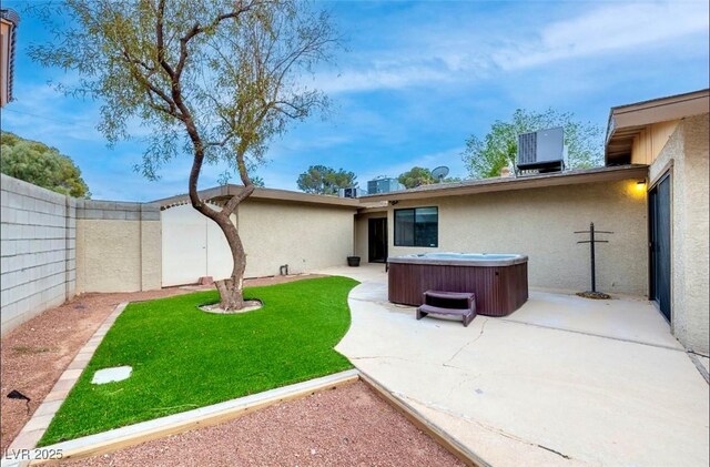 3597 Cochise Ln, Las Vegas, NV 89169 - fenced backyard featuring a hot tub and a patio