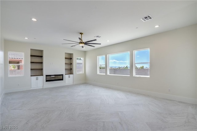 1525 Heights Dr, Logandale, NV 89021 - unfurnished living room with a ceiling fan, built in shelves, and recessed lighting