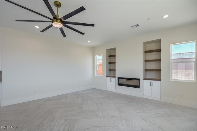 1525 Heights Dr, Logandale, NV 89021 - unfurnished living room featuring built in shelves, recessed lighting, and ceiling fan