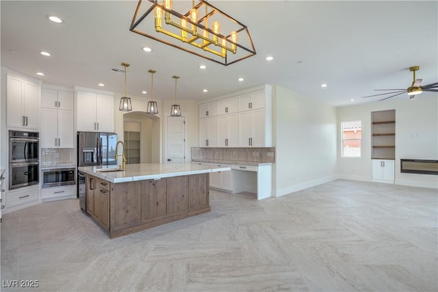 1525 Heights Dr, Logandale, NV 89021 - kitchen with stainless steel appliances, open floor plan, decorative backsplash, a large island, and recessed lighting